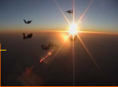 Skydivers in sunset